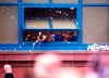Rangers' Alfredo Morelos looks from a window as he celebrates with fans outside the ground after winning in the Scottish Premiership match against St Mirren, at Ibrox Stadium in Glasgow, Scotland, Saturday March 6, 2021. Some thousands of fans gathered outside the stadium celebrating the win against St. Mirren, putting them on the brink of securing the Scottish Premiership title. (Robert Perry/PA via AP)