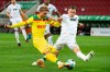 Sebastian Andersson of Koln, left, in action with Jeffrey Gouweleeuw of Augsburg during their German Bundesliga Soccer match at WWK Arena in Augsburg, Germany, Friday April 23, 2021.(Matthias Balk/dpa via AP)