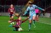 Servette's defender Amandine Soulard, left, fights for the ball with Atletico Madrid's forward Toni Duggan, during their Women's Champions League round of 32 first leg soccer match at the Stade de Geneve stadium, in Geneva, Switzerland, Wednesday, Dec. 9, 2020. The match is played behind closed doors due to the coronavirus COVID-19 pandemic. (Salvatore Di Nolfi/Keystone via AP)