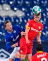 Leverkusen's Lars Bender, right, challenged by Schalke's Bastian Oczipka during their German Bundesliga soccer match at the Veltins Arena in Gelsenkirchen, Germany, Sunday Dec. 6, 2020. (Guido Kirchner/pool via AP)