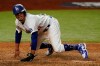 Los Angeles Dodgers' Mookie Betts scores on a fielders choice by Max Muncy during the fifth inning in Game 1 of the baseball World Series against the Tampa Bay Rays Tuesday, Oct. 20, 2020, in Arlington, Texas. (AP Photo/Eric Gay)