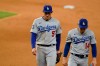 Los Angeles Dodgers shortstop Corey Seager (5) and Enrique Hernandez walk off the field after Game 4 of the baseball World Series Saturday, Oct. 24, 2020, in Arlington, Texas. Rays defeated the Dodgers 8-7 to tie the series 2-2 games. (AP Photo/Eric Gay)
