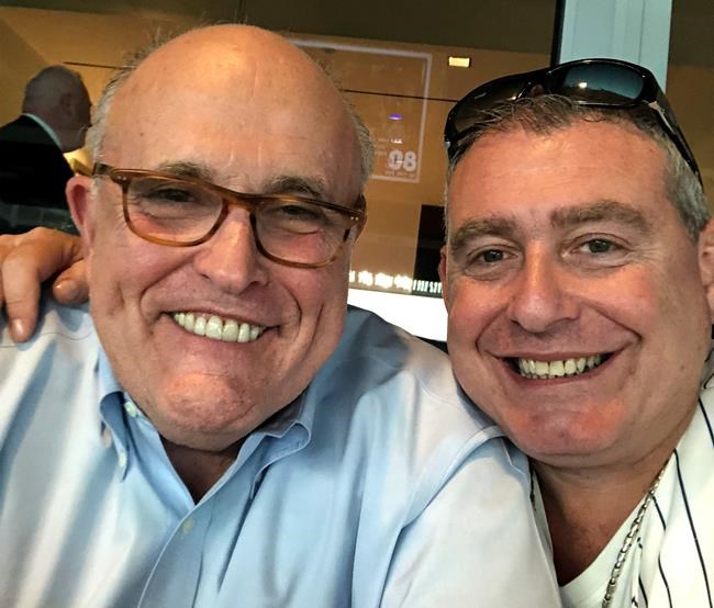 This undated image released by the House Judiciary Committee from documents provided by Lev Parnas to the committee in the impeachment probe against President Donald Trump, shows a photo of Lev Parnas with Rudy Giuliani. Parnas, a close associate of Trump's personal lawyer Giuliani is claiming Trump was directly involved in the effort to pressure Ukraine to investigate Democratic rival Joe Biden. Trump on Thursday, Jan. 16, 2020, repeated denials that he is acquainted with Parnas, despite numerous photos that have emerged of the two men together.(House Judiciary Committee via AP)
