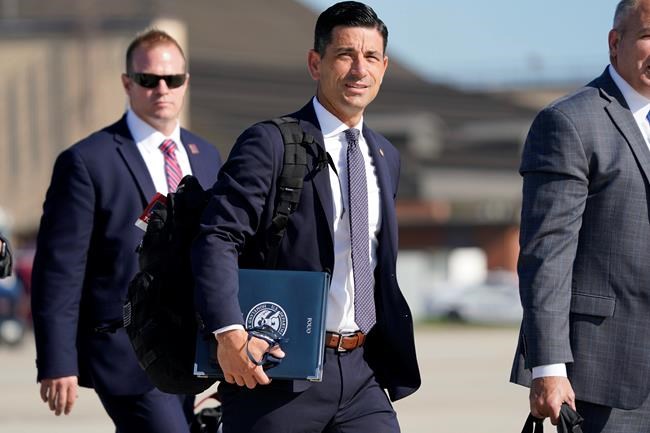 FILE - In this Aug. 18, 2020, file photo acting-Secretary of Homeland Security Chad Wolf, center, arrives to join President Donald Trump at Andrews Air Force Base in Md. In December, U.S. officials discovered that federal agencies had fallen victim to a cyberespionage effort pulled off largely through a hack of SolarWinds software .The hackers accessed accounts belonging to then-acting Secretary Chad Wolf and staff at the Cybersecurity and Infrastructure Security Agency who focus on finding cyber threats from nation-state adversaries like Russia, according to current and former senior Homeland Security Department and intelligence officials who were briefed on the extent of the breach. (AP Photo/J. Scott Applewhite, File)