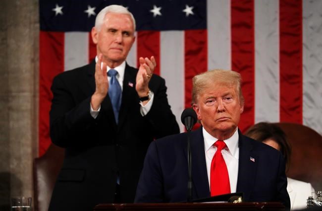 President Donald Trump delivers his State of the Union address to a joint session of Congress in the House Chamber on Capitol Hill in Washington, Tuesday, Feb. 4, 2020, as Vice President Mike Pence applauds. (Leah Millis/Pool via AP)