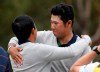 International team players C.T. Pan of Taiwan, right, and Hideki Matsuyama of Japan embrace after winning their fourball match during the President's Cup golf tournament at Royal Melbourne Golf Club in Melbourne, Saturday, Dec. 14, 2019. (AP Photo/Andy Brownbill)