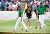 International team player Abraham Ancer of Mexico, left, and playing partner Marc Leishman of Australia, right, survey the 16th green in their foursomes match during the President's Cup golf tournament at Royal Melbourne Golf Club in Melbourne, Friday, Dec. 13, 2019. (AP Photo/Andy Brownbill)