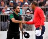 U.S. team player and captain Tiger Woods, right, shakes hands with International team player Abraham Ancer of Mexico after Woods won their singles match 3 and 2 during the President's Cup golf tournament at Royal Melbourne Golf Club in Melbourne, Sunday, Dec. 15, 2019. (AP Photo/Andy Brownbill)