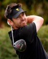 International team player Louis Oosthuizen of South Africa tees off at the 9th hole during their fourball match at the Royal Melbourne Golf Club in the opening rounds of the President's Cup golf tournament in Melbourne, Thursday, Dec. 12, 2019. (AP Photo/Andy Brownbill)