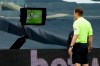 Referee Peter Bankes watches a monitor during the English Premier League soccer match between Tottenham and Newcastle at the Tottenham Hotspur Stadium in London, Sunday, Sept. 27, 2020. (Andrew Boyers/Pool via AP)