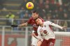 AC Milan's Alessio Romagnoli, left, jumps for the ball with Torino's Alex Berenguer during the Serie A soccer match between AC Milan and Torino at the San Siro stadium, in Milan, Italy, Monday, Feb. 17, 2020. (AP Photo/Antonio Calanni)