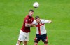 AC Milan's Alessio Romagnoli challenges for the ball with Genoa's Goran Pandev, right, during the Serie A soccer match between AC Milan and Genoa at the San Siro stadium, in Milan, Italy, Sunday, March 8, 2020. (AP Photo/Antonio Calanni)