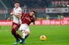 AC Milan's Hakan Calhanoglu, right, scores his side's second goal during an Italian Cup quarter finals soccer match between AC Milan and Torino at the San Siro stadium, in Milan, Italy, Tuesday, Jan. 28, 2020. (AP Photo/Antonio Calanni)