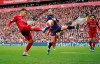 Liverpool's Roberto Firmino, left, challenges for the ball with Bournemouth's Adam Smith, center, as Liverpool's Mohamed Salah looks them during the English Premier League soccer match between Liverpool and Bournemouth at Anfield stadium in Liverpool, England, Saturday, March 7, 2020. (AP Photo/Jon Super)