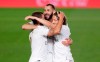 Real Madrid's Karim Benzema, center, celebrates with his teammates Eden Hazard, left, and Luka Modric after scoring his side's opening goal during the Spanish La Liga soccer match between Real Madrid and Valencia at Alfredo di Stefano stadium in Madrid, Spain, Thursday, June 18, 2020. (AP Photo/Manu Fernandez)