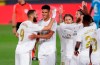 Real Madrid's Karim Benzema, left, celebrates with his teammates after scoring his side's third goal during the Spanish La Liga soccer match between Real Madrid and Valencia at Alfredo di Stefano stadium in Madrid, Spain, Thursday, June 18, 2020. Real Madrid won 3-0. (AP Photo/Manu Fernandez)