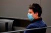 Portuguese hacker Rui Pinto sits in the courtroom at the start of his trial in Lisbon, Friday, Sept. 4, 2020. Lisbon court is hearing the case against 31-year-old Pinto, whose explose was published over financial revelations about European soccer players, top clubs, influential agents and continental officials. (AP Photo/Armando Franca)