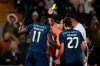 Referee Luis Godinho shows a yellow card to Porto's Moussa Marega, left, during a Portuguese league soccer match between Vitoria SC and FC Porto in Guimaraes, Portugal, Sunday, Feb. 15, 2020. The president and the prime minister of Portugal have added their voices to a national outcry over racist abuse aimed at Moussa Marega who walked off the field after hearing monkey chants. (AP Photo)