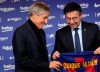 Soccer coach Quique Setien smiles with FC Barcelona's President Josep Maria Bartomeu, right, while being officially introduced as the club's new coach at the Camp Nou stadium in Barcelona, Spain, Tuesday, Jan. 14, 2020. Barcelona made a rare coaching change midway through the season, replacing Ernesto Valverde with former Real Betis manager Quique Setien on Monday. (AP Photo/Emilio Morenatti)