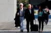 French lawyer William Bourdon, left, and Portuguese lawyer Francisco Teixeira da Mota, centre, the lawyers of Portuguese hacker Rui Pinto, arrive for the start of his trial in Lisbon, Friday, Sept. 4, 2020. The Lisbon court is hearing the case against 31-year-old Pinto, whose expose was published over financial revelations about European soccer players, top clubs, influential agents and continental officials. (AP Photo/Armando Franca)