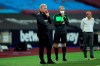 West Ham's manager David Moyes, left, and Charlton Athletic's manager Lee Bowyer, right, stand by the touchline during the English League Cup soccer match between West Ham United and Charlton Athletic at London stadium in London, Tuesday, Sept. 15, 2020. (Adam Davy/Pool via AP)