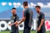 Barcelona players Lionel Messi, Gerard Pique and Sergi Roberto, from left to right, chat during a training session at the Luz stadium in Lisbon, Thursday Aug. 13, 2020. Barcelona will play Bayern Munich in a Champions League quarterfinals soccer match on Friday. (AP Photo/Manu Fernandez, Pool)