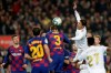Real Madrid's Raphael Varane, top right, jumps for the ball with Barcelona's Gerard Pique, center, during a Spanish La Liga soccer match between Barcelona and Real Madrid at Camp Nou stadium in Barcelona, Spain, Wednesday, Dec. 18, 2019. Thousands of Catalan separatists are planning to protest around and inside Barcelona's Camp Nou Stadium during Wednesday's 