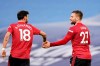 Manchester United's Luke Shaw celebrates with Bruno Fernandes, left, after scoring his side's second goal during the English Premier League soccer match between Manchester City and Manchester United at the Etihad Stadium in Manchester, England, Sunday, March 7, 2021. (Dave Thompson/Pool via AP)