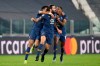 Porto's Sergio Oliveira, center, celebrates after scoring his side's second goal during the Champions League, round of 16, second leg, soccer match between Juventus and Porto in Turin, Italy, Tuesday, March 9, 2021. (AP Photo/Luca Bruno)