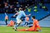 Manchester City's Ilkay Gundogan, center, celebrates after scoring his side's third goal during the English Premier League soccer match between Manchester City and Tottenham Hotspur at Etihad Stadium, Manchester, England, Saturday, Feb. 13, 2021. (Shaun Botterhill/Pool via AP)