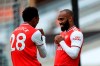 Arsenal's Alexandre Lacazette celebrates with Joe Willock, left, after scoring his side's second goal during the English Premier League soccer match between Wolverhampton Wanderers and Arsenal at the Molineux Stadium in Wolverhampton, England, Saturday, July 4, 2020. (Mike Egerton/Pool via AP)