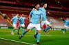 Manchester City's Ilkay Gundogan celebrates with Bernardo Silva, center right, after scoring the opening goal during the English Premier League soccer match between Liverpool and Manchester City at Anfield Stadium, Liverpool, England, Sunday, Feb. 7, 2021. (AP photo/Jon Super, Pool)