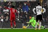Liverpool's Mohamed Salah, left, scores his side's first goal from the penalty spot during the English Premier League soccer match between Fulham and Liverpool, at Craven Cottage stadium, London, Sunday, Dec. 13, 2020. (Neil Hall/Pool via AP)