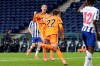 Juventus' Cristiano Ronaldo celebrates after teammate Federico Chiesa, center, scored their side's first goal during the Champions League round of 16, first leg, soccer match between FC Porto and Juventus at the Dragao stadium in Porto, Portugal, Wednesday, Feb. 17, 2021. (AP Photo/Luis Vieira)