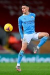 Manchester City's Phil Foden controls the ball during the English Premier League soccer match between Liverpool and Manchester City at Anfield Stadium, Liverpool, England, Sunday, Feb. 7, 2021. (Laurence Griffiths/Pool via AP)