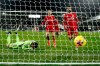 Liverpool's Mohamed Salah, right, runs to retrieve the ball after scoring from the penalty spot during the English Premier League soccer match between Fulham and Liverpool, at Craven Cottage stadium, London, Sunday, Dec. 13, 2020. (AP photo/Matt Dunham, Pool)
