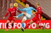 Manchester City's Phil Foden controls the ball between Liverpool's Jordan Henderson, left, and Liverpool's Fabinho during the English Premier League soccer match between Liverpool and Manchester City at Anfield Stadium, Liverpool, England, Sunday, Feb. 7, 2021. (AP photo/Jon Super, Pool)