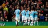 Manchester City's Bernardo Silva, right, is mobbed by his teammates after scoring the opening goal of the game during the English League Cup semifinal first leg soccer match between Manchester United and Manchester City and at Old Trafford, Manchester, England, Tuesday, Jan. 7, 2020. (AP Photo/Jon Super)