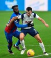Crystal Palace's Jeffrey Schlupp, left vies for the ball with Tottenham's Sergio Reguilon during their English Premier League soccer match between Crystal Palace and Tottenham Hotspur at Selhurst Park in London, Sunday, Dec., 13, 2020. (Glyn Kirk/ Pool via AP))