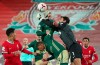 Liverpool's goalkeeper Alisson punches clear as Sheffield United's Oliver McBurnie eyes the ball during the English Premier League soccer match between Liverpool and Sheffield United at Anfield in Liverpool, England, Saturday, Oct. 24, 2020. (Peter ByrnePool via AP)