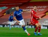 Everton's Richarlison, left, celebrates after scoring the opening goal of the game during the English Premier League soccer match between Liverpool and Everton at Anfield in Liverpool, England, Saturday, Feb. 20, 2021. (Phil Noble/ Pool via AP)