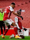 Arsenal's Nicolas Pepe, right, celebrates with teammate Arsenal's Pierre-Emerick Aubameyang after scoring his sides second goal during the English Premier League soccer match between Arsenal and Sheffield United at the Emirates Stadium in London, Sunday, Oct. 4, 2020. (AP Photo/Kirsty Wigglesworth)
