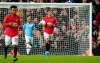 Manchester United's Marcus Rashford carries the ball back to the centre circle after he scored his sides first goal of the game during the English League Cup semifinal first leg soccer match between Manchester United and Manchester City and at Old Trafford, Manchester, England, Tuesday, Jan. 7, 2020. (AP Photo/Jon Super)