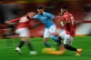 Manchester City's Riyad Mahrez, center, attempts to get past Manchester United's Fred during the English Premier League soccer match between Manchester United and Manchester City at Old Trafford in Manchester, England. Saturday, Dec. 12, 2020. There have been 150 top-flight Man U v Man City derbies with United having won 58 and City 45, with 47 draws. (AP Photo/Michael Regan/ Pool via AP)