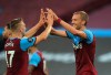 West Ham's Tomas Soucek, right celebrates with teammate West Ham's Jarrod Bowen after scoring his sides first goal during the English Premier League soccer match between West Ham United and Chelsea at the London Stadium in London, Wednesday, July, 1, 2020. (Adam Davy/Pool via AP)