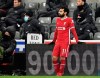 Liverpool's Mohamed Salah rests on a side board after being substituted during the English Premier League soccer match between Newcastle United and Liverpool at St James' Park stadium in Newcastle, England, Wednesday, Dec. 30, 2020. (Peter Powell/ Pool via AP)
