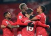Manchester United's Bruno Fernandes, (18), celebrates with teammates after scoring his sides 2nd goal of the game from the penalty spot during the English Premier League soccer match between Manchester United and Aston Villa at Old Trafford in Manchester, England, Friday, Jan. 1, 2021. (Carl Recine/ Pool via AP)