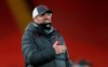 Liverpool's manager Jurgen Klopp celebrates towards the fans after the end of the English Premier League soccer match between Liverpool and Tottenham Hotspur at Anfield in Liverpool, England, Wednesday, Dec., 16, 2020. Liverpool won the game 2-1. (Clive Brunskill/ Pool via AP)
