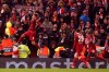 FILE - In this file photo taken on March 11, 2020, Liverpool's Roberto Firmino celebrates after scoring his side's second goal during a Champions League soccer match between Liverpool and Atletico Madrid at Anfield stadium in Liverpool, England. The Premier League trophy should have been in Liverpool‚Äôs hands by now. This week should have featured a victory parade through the streets of Liverpool. But the wait to end the 30-year title drought goes on. (AP Photo/Jon Super)