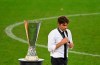 FILE - In this Aug. 21, 2020 file photo, Inter Milan's head coach Antonio Conte walks past the trophy after the Europa League final soccer match between Sevilla and Inter Milan in Cologne, Germany. With the new Serie A season set to begin this weekend, the annual question arises: can anyone stop Juventus? (Ina Fassbender/Pool via AP)
